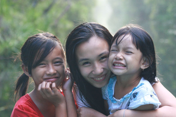 Ana Sofía Wang and two girls from ASRI Kids bond while working to restore the environment. 