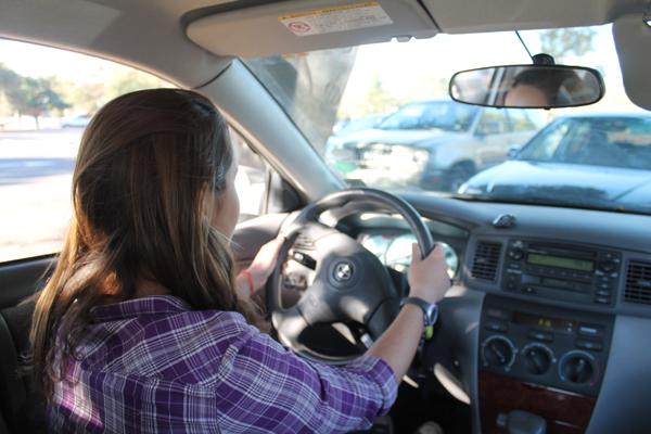 A Paly student looks out waiting to drive her car