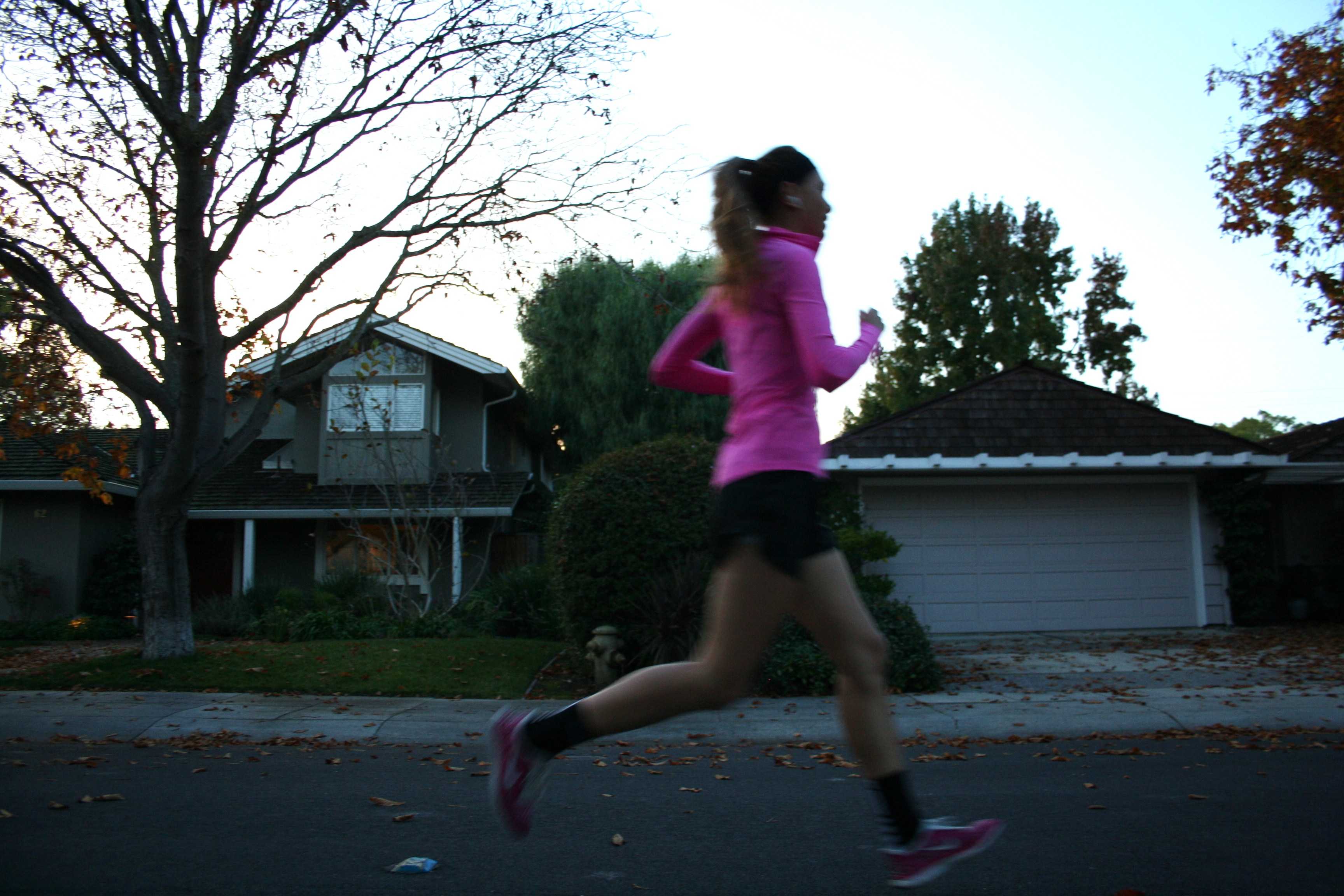 A Palo Alto resident runs through her neighborhood