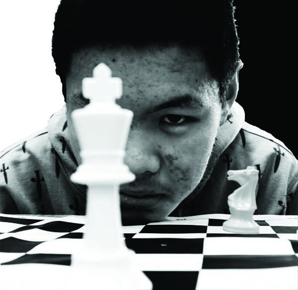 THE FISCHER KING: Chess Club president Wilson Wang poses in a re-creation of a photo of chess player Bobby Fischer taken by Philippe Halsman in 1967. “I’ve looked at a number of his games” says freshman chess club member James Pederson of Fischer.  “Even when he was a child he was still an excellent chess player. “ [Charu Srivastava]