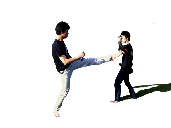 KICKING: Ben Lin (left) coaches Gavin Chan (right) with taekwondo drills at Piers Park in early spring. Chan focuses on keeping his head and arms up while performing high kicks. 