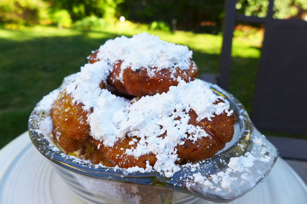 These fluffy New Orleans doughnuts are drizzled with honey and covered in powdered sugar