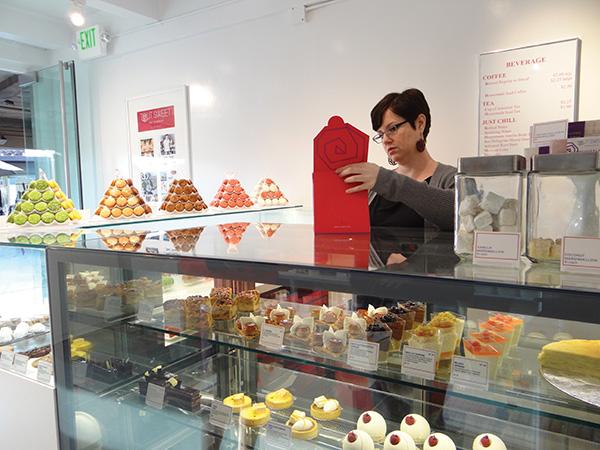 Palo Alto store manager Brandi Davis packages a box full of pastries.