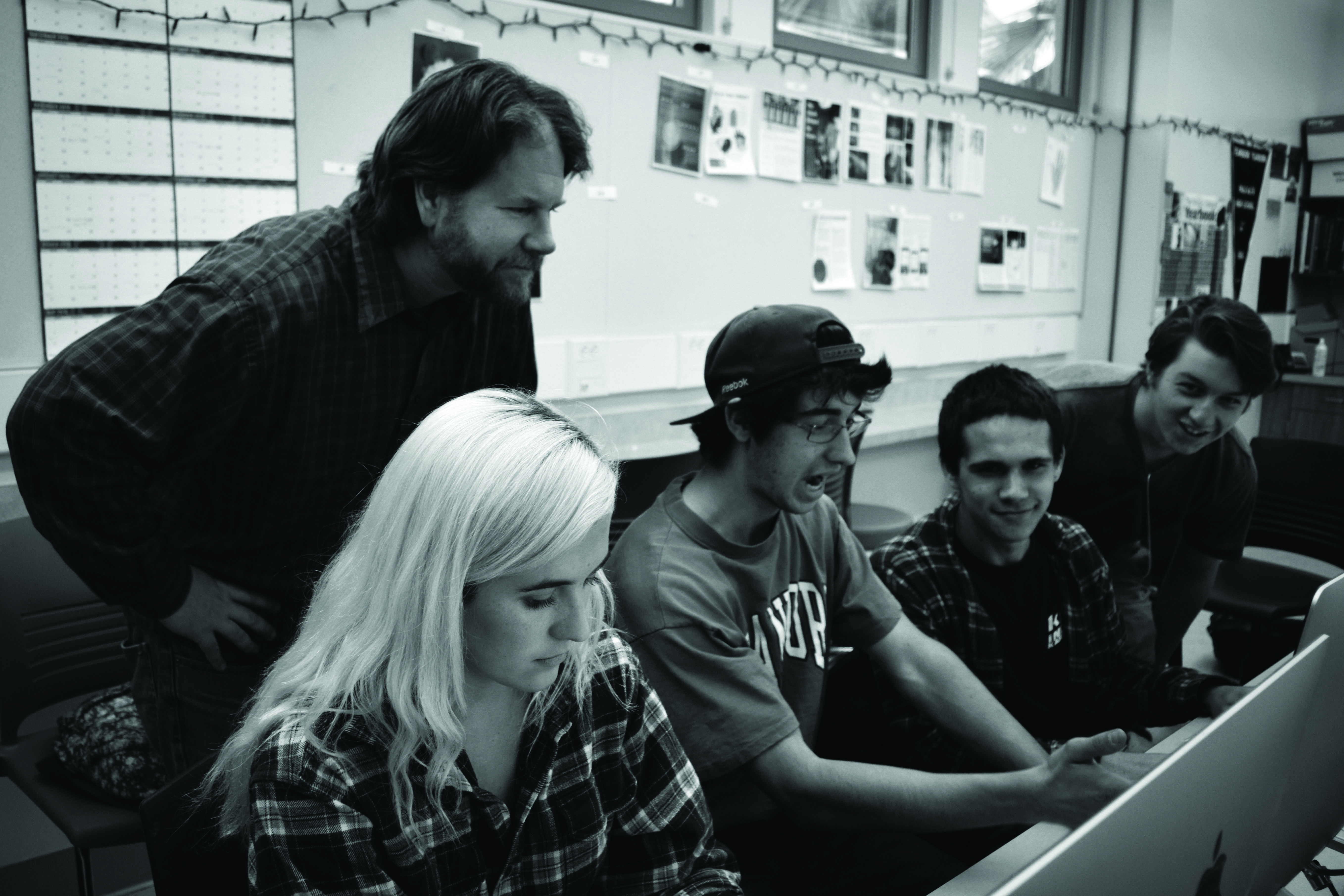 Brian Wilson helps yearbook students (from left to right) Nika Nikanorov, Liam Nororian, Blake Ragsdale and Dimi Zlatkov with page design. 
