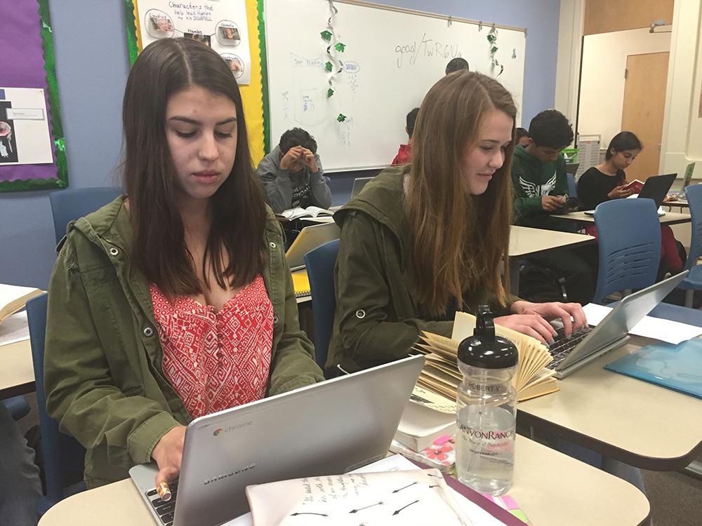 Sophomores Emma Villareal and Isabella Marcus type on the classroom set of Chromebooks in their English class