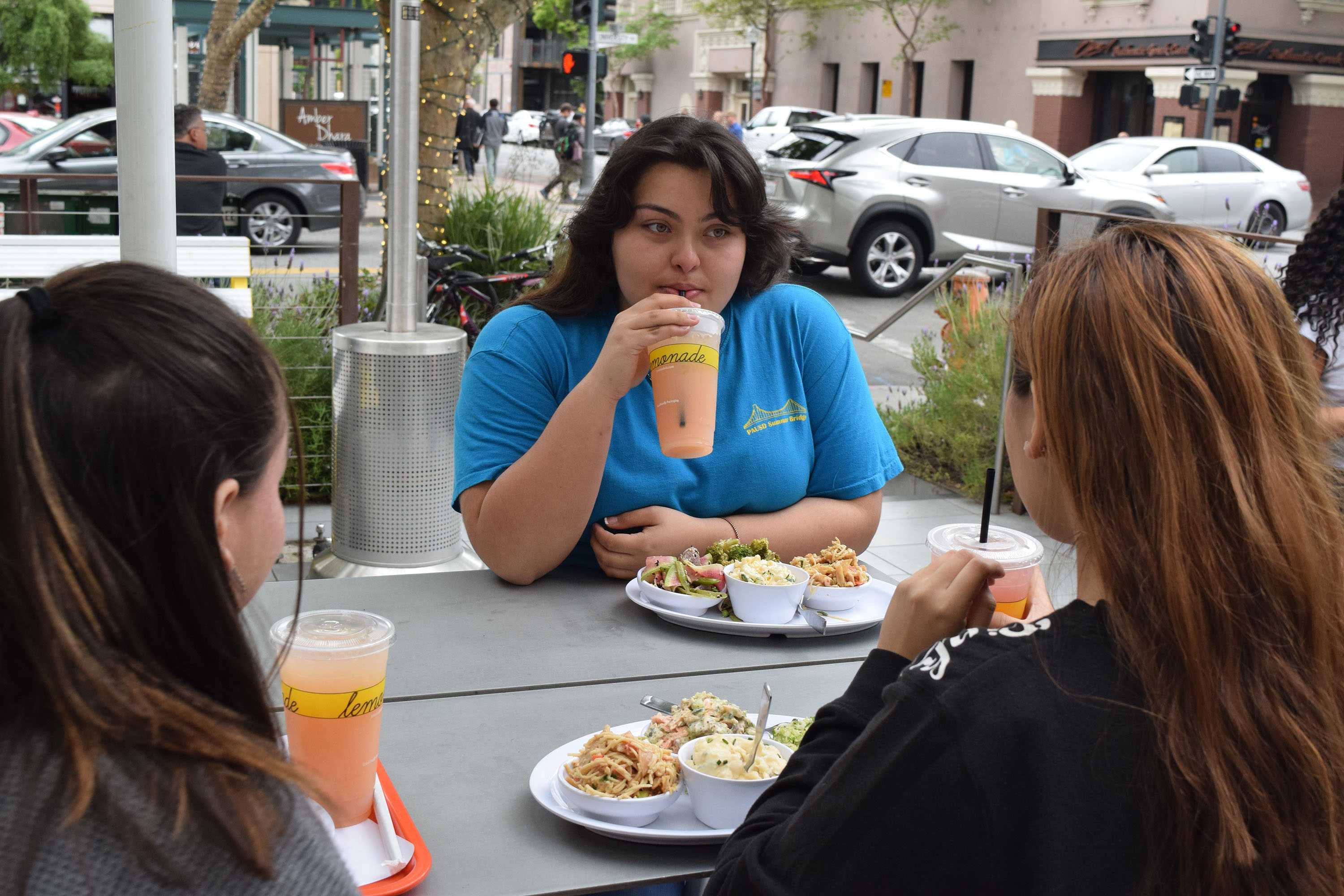 Palo Alto High School junior Alexa Morales enjoys her meal and drink at Lemonade with her friends after a minimum day. 