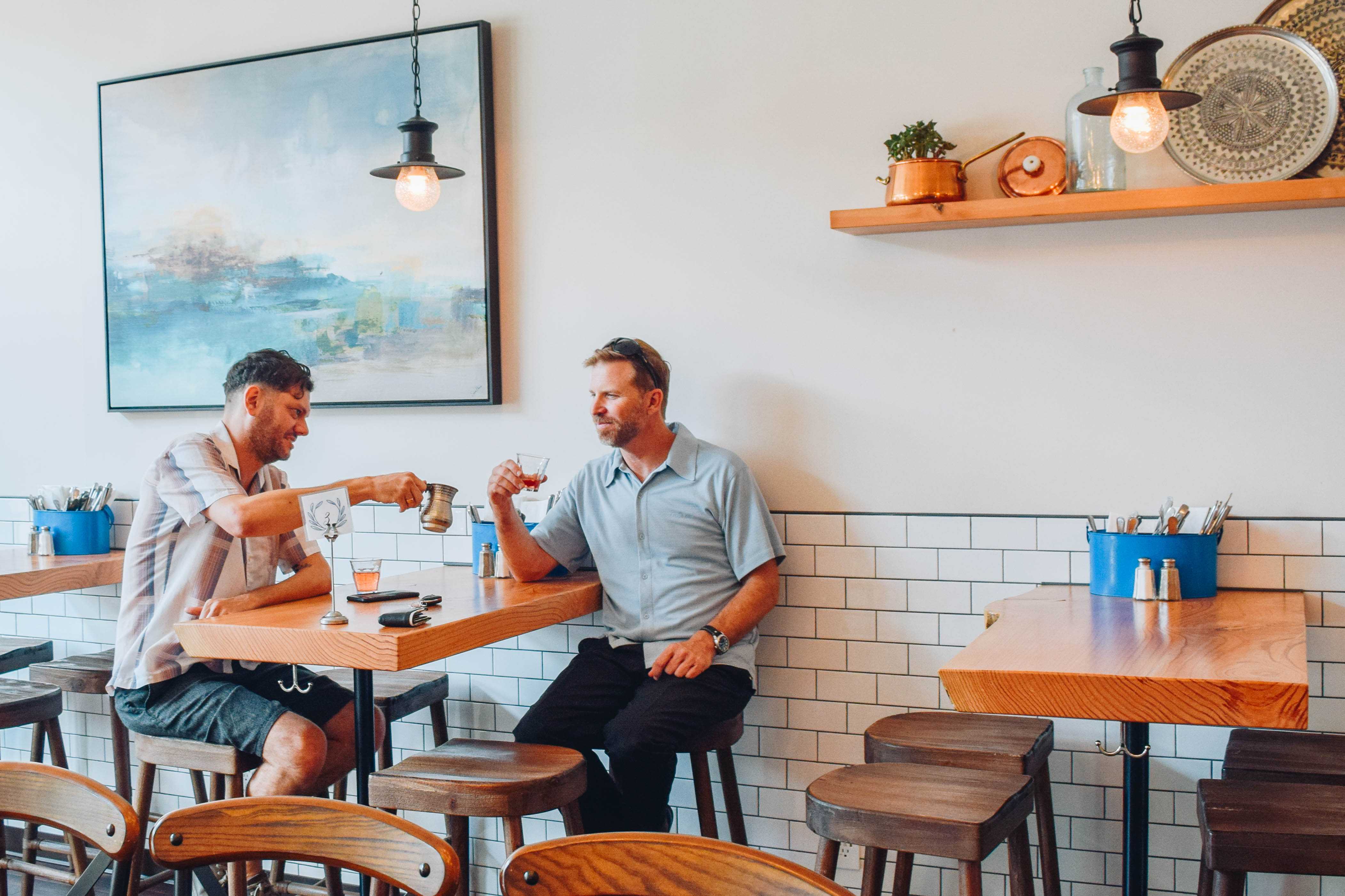 TAKE A SIP Customers Max Weiss (left) and Chris Wellise (right) relax as they wait for their food to arrive.  Photo by Ella Thomsen