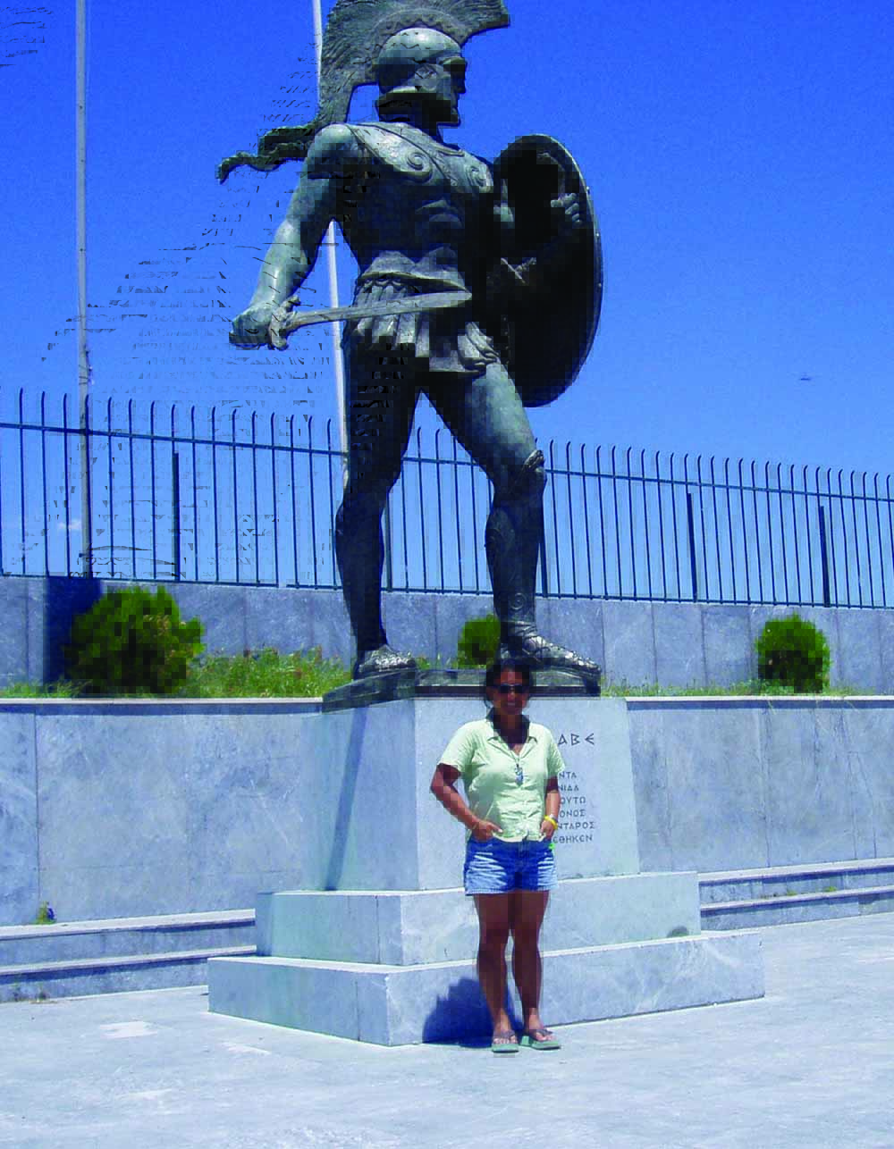Sano strikes a pose under a statue of a Spartan soldier