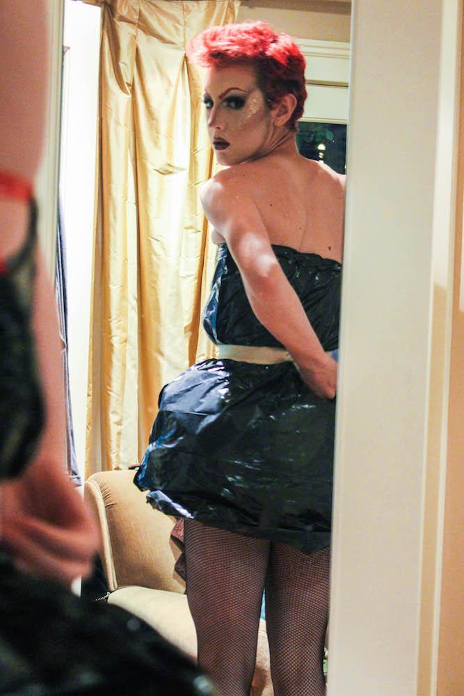 MIRROR MIRROR Sophomore Atticus Scherer gets ready for the Homecoming  dance in a dress made from a trash bag. Scherer has been experimenting with drag makeup since he was 12 years old. It [drag] makes me unique, Scherer says. 