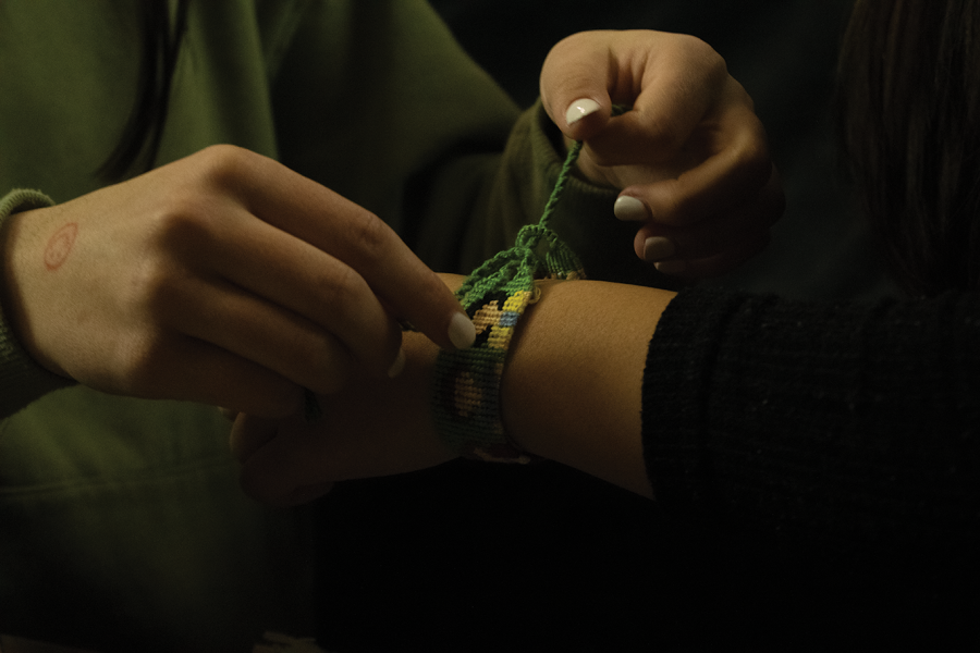 KNOT TO BE UNDONE — After picking out a Stranger Things-inspired friendship bracelet, Palo Alto High School sophomore Katelyn Pegg ties it around her friends wrist. I definitely want to try and keep it [her business] going as long as possible, Pegg said. Im thinking of maybe going into some form of business after high school, but I dont have it all figured out yet. Photo: Madelyn Castro