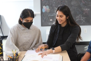 STUDYING WITH A SMILE — Mehr Sikri reviews a math test with Palo Alto High School sophomore Mansavi Noronha. “It’s a very warm and supportive environment and I’m very hands-on and invested in each and every one of our students,” Sikri said. Photo: Rahul Shetty