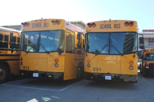 BRAND NEW BUSES — Palo Alto Unified School District’s new electric buses patiently await their first rides next fall. The buses will need to pass through a trial to ensure safety and determine their battery life. “We are going to be looking at the distance and the amount of time we can drive the bus before we have to put it back on the charger,” Chow said. “So it’ll be a learning experience.” Photo: Lizzy Williams