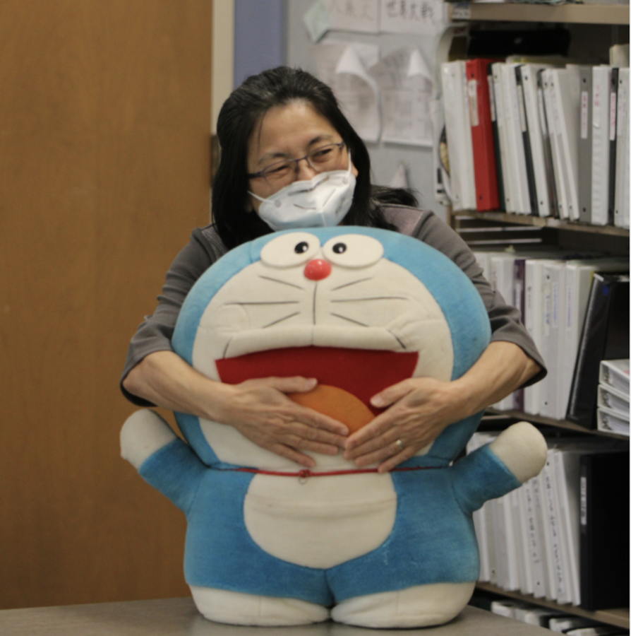 HUGGING THE MEMORIES — Palo Alto High School’s Japanese teacher Teruko Kamikihara hugs one of her many “Doraemon” plushies. “[Paly] students are friendly and respect each other,” Kamikihara said. “Especially my students. They are really good students.” Photo: Rahul Shetty