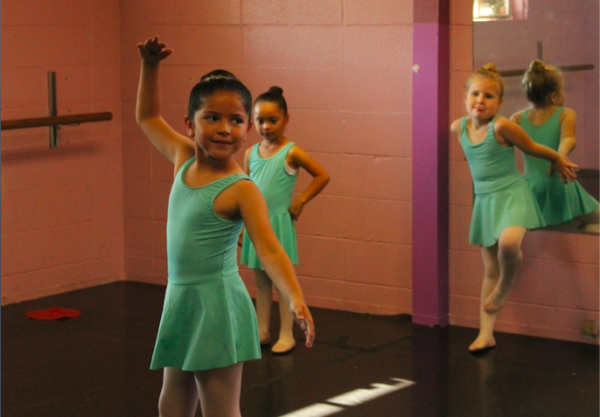LOOKING BEYOND — An En Avant School of Dance student twirls around in her dance class. Kennedys project, its one of the factorsthat helps make sure that the kids in East Palo Alto have similar opportunities as more wealthy families like in Palo Alto,” Cottam said. Photo: Cate Graney

