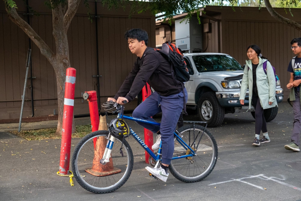 HOMEWARD BOUND —  Junior Evan Chang rides his bike on his way out of school. He reflects on current bike safety in Palo Alto “I think changes would always be beneficial,” Chang said. “Theres always things to improve upon with the biking system.”