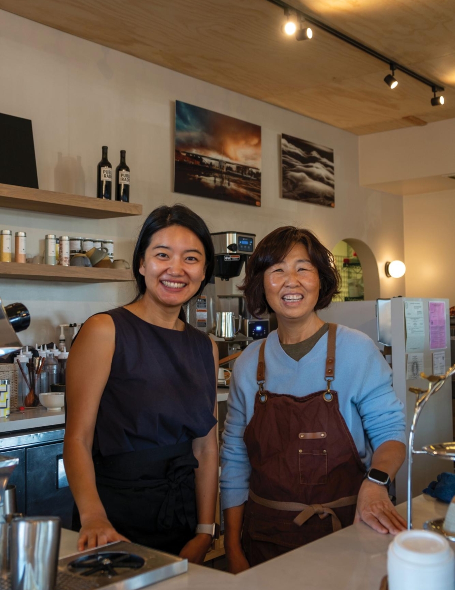 BEHIND THE COUNTER — Amid the busy Saturday morning coffee rush, Cloud9 Coffee co-owners Hanna Joo and Elizabeth Kim laugh as they crack jokes to each other. “I hope [people] find a place where they can rest and enjoy good coffee and good food that’s not too far from home,” Joo said.