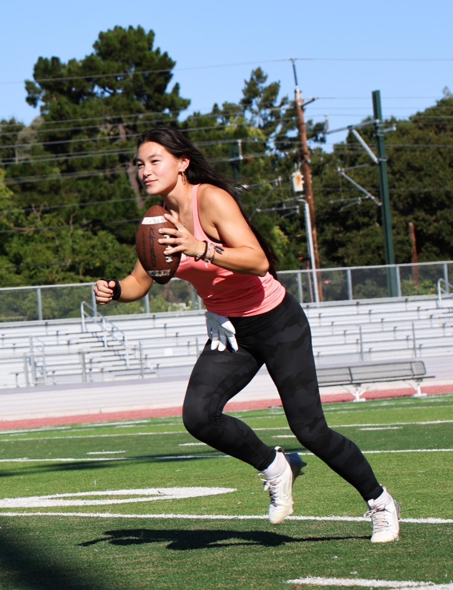 CATCH ME IF YOU CAN — Junior Kailia Leming dashes across the  football field during practice. “It’s super fun being one of the first girls on Paly’s flag football team, and one of the firsts on a high school flag football team in California.”