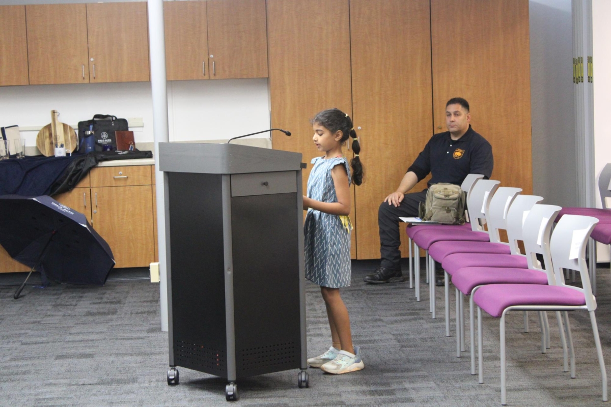 STANDING UP, SPEAKING OUT — Hoover third grader Rupali Rao speaks to the Palo Alto school board on Sept. 10 about her experiences with all gender restrooms at Hoover Elementary. “A boy has punched me in the stomach and spit on me,” Rupali Rao said. “I really do not feel comfortable in an all-gender restroom.” 