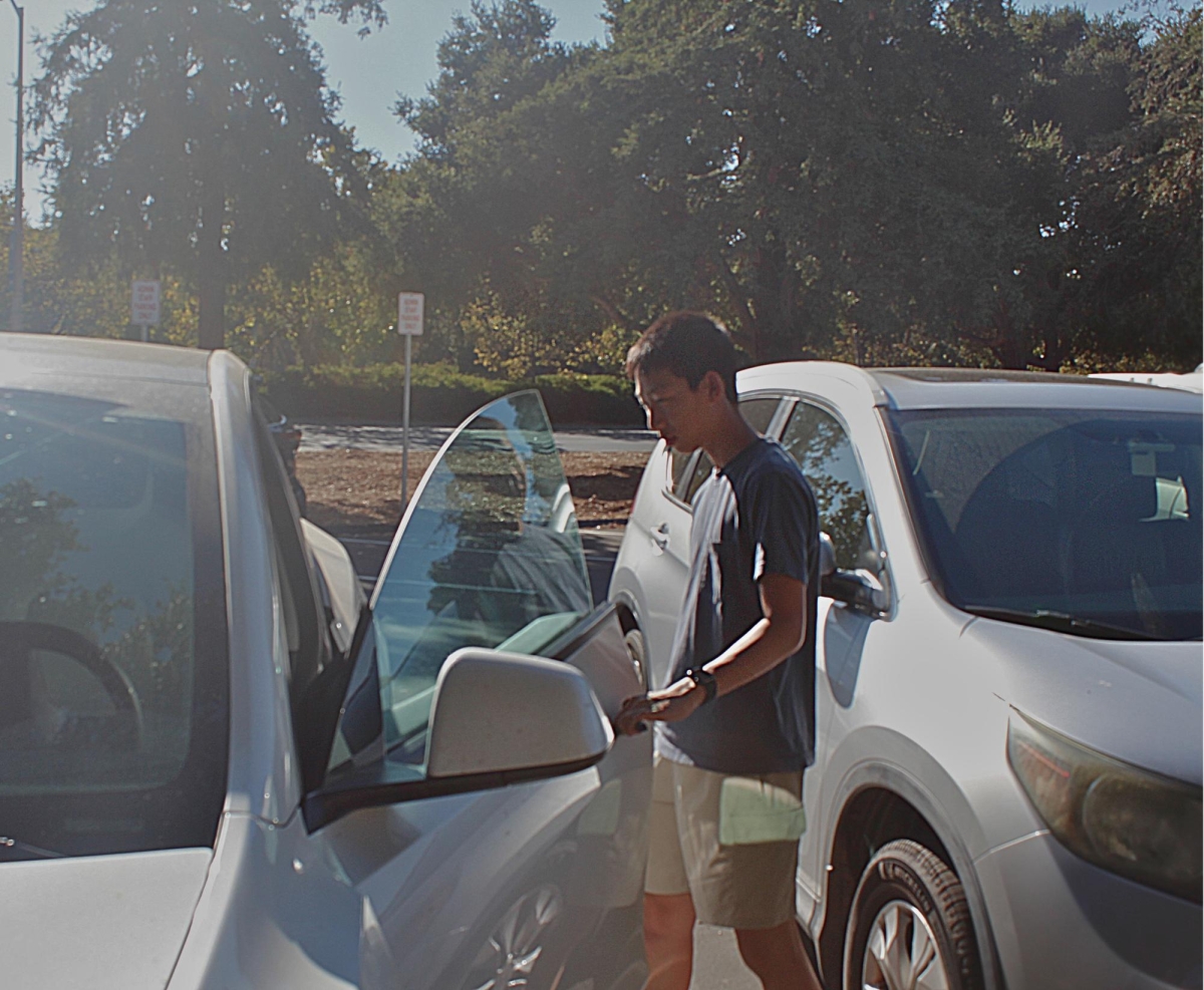 PARKING PROBLEMS—Paly sophomore Aiden Miao enters his car in the parking lot after school. Assistant Principal Jerry Berkson said it will be difficult to find parking spaces after the bike lanes are implemented. “That is an issue we might have to address moving forward,” Berkson said.