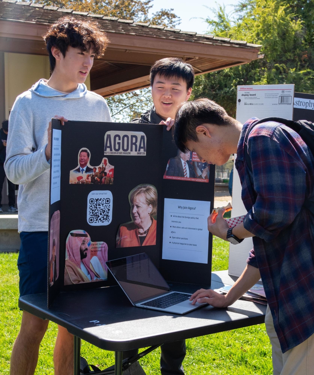  CLUB CONNECTIONS — A Paly student signs up for Agora Magazine, a foreign policy magazine club. Junior Meryem Orazova enjoyed exploring all 143 clubs that are being offered this year. “I think it’s really cool seeing all these amazing clubs,” Orazova said. “They’re very creative and a lot of them are super niche which is interesting to see.” 
