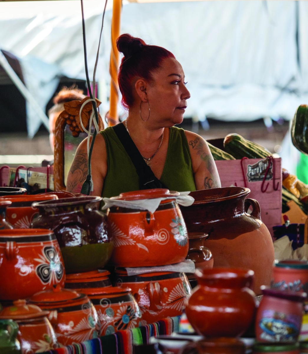 MEANINGFUL MARKET — A vase seller looks off into the distance at the San Jose Flea Market. “It [the announcement of the closure] really had a big impact on us,” vendor Nancy Torres said.
