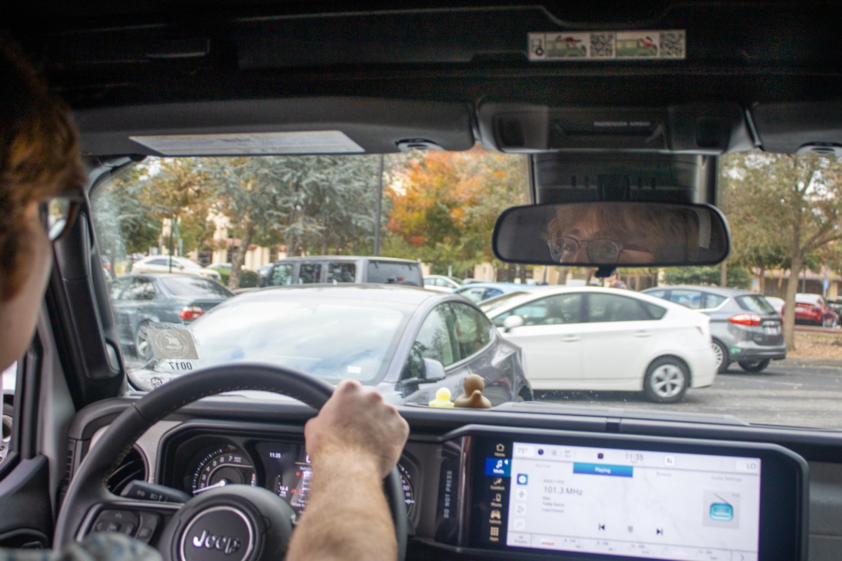 SEEKING A SPOT — Palo Alto High School junior Jonathan Bakhash looks out from his car towards the parking lot. “It [driving to school] has been really helpful. Just having my stuff [sports equipment] so my parents don't have to drop it off,” Bakhash said.