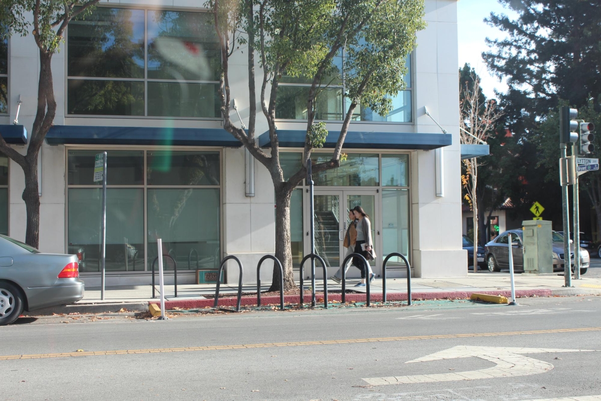 BROWSING BRYANT — Two people walk past 445 Bryant St., which is going to host a community center focused on teenagers and senior citizens.“To be able to find this one city space, to be able to use both [teen and senior citizen spaces], surpassed my expectations at the beginning of the entire process,” Palo Alto Mayor Greer Stone said. 
