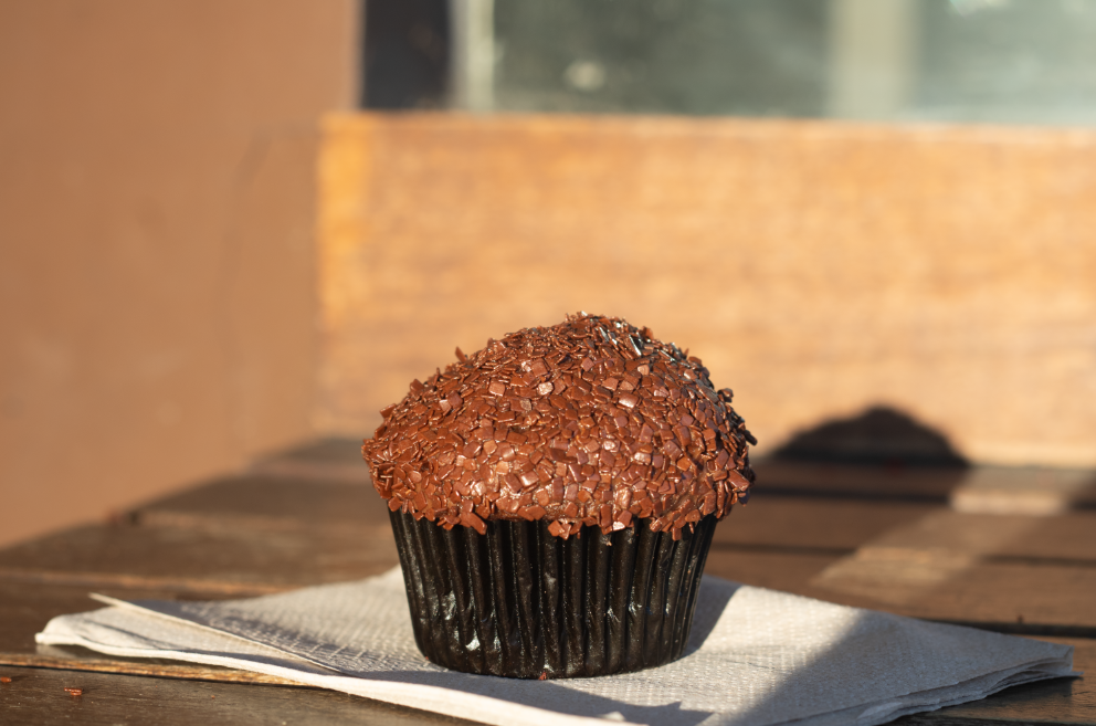 CHOCOLATE CUPCAKE — Sprinkles, located at Stanford Shopping Center in Palo Alto, is a chain that sells cupcakes and other baked goods. Pictured is a dark chocolate cupcake, made with Belgian Dark Chocolate cake topped with bittersweet chocolate frosting and chocolate paillettes.