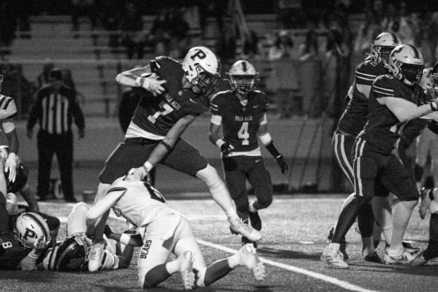 VAULTING VIKING — Palo Alto High School junior and wide receiver Clement Romanski hurdles over an opposing player while running the ball.