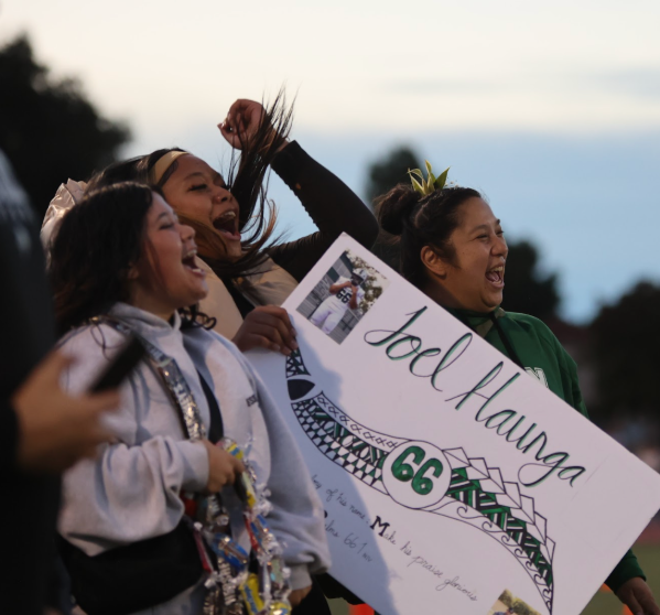 CHEER ON — Friends and mentors cheer on Paly football seniors. On Oct. 24, Paly football, band, cheer and dance celebrated senior night at the Earl Hansen Viking Stadium.
