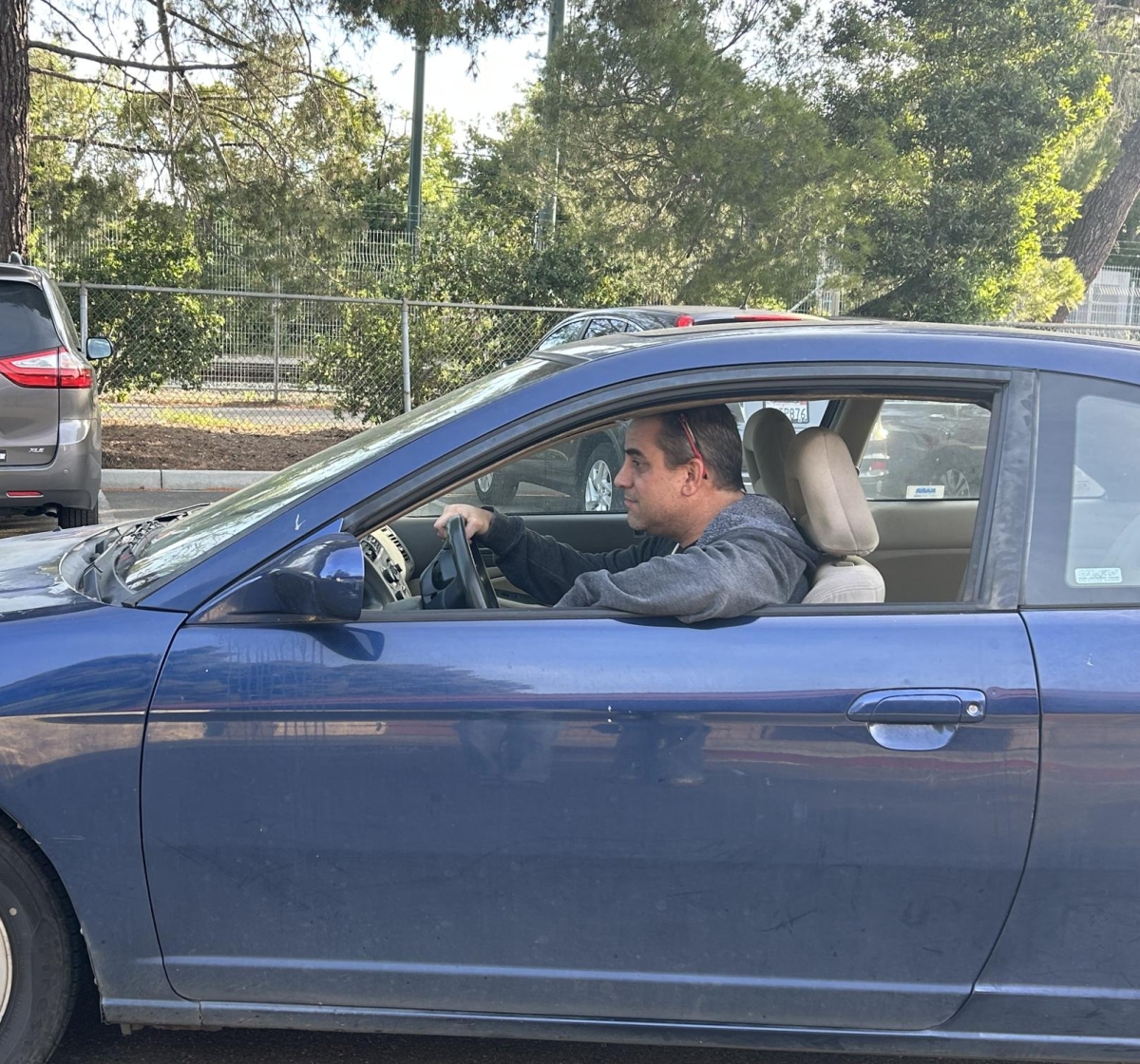 DRIVING HOME — Paly economics teacher Grant Blackburn navigates a school parking lot. He used to commute from Santa Clara, and would have to spend a lot of money on gas. "I would be having to go and fill up my gas tank once every three days," Blackburn said. "That's almost twice a week."