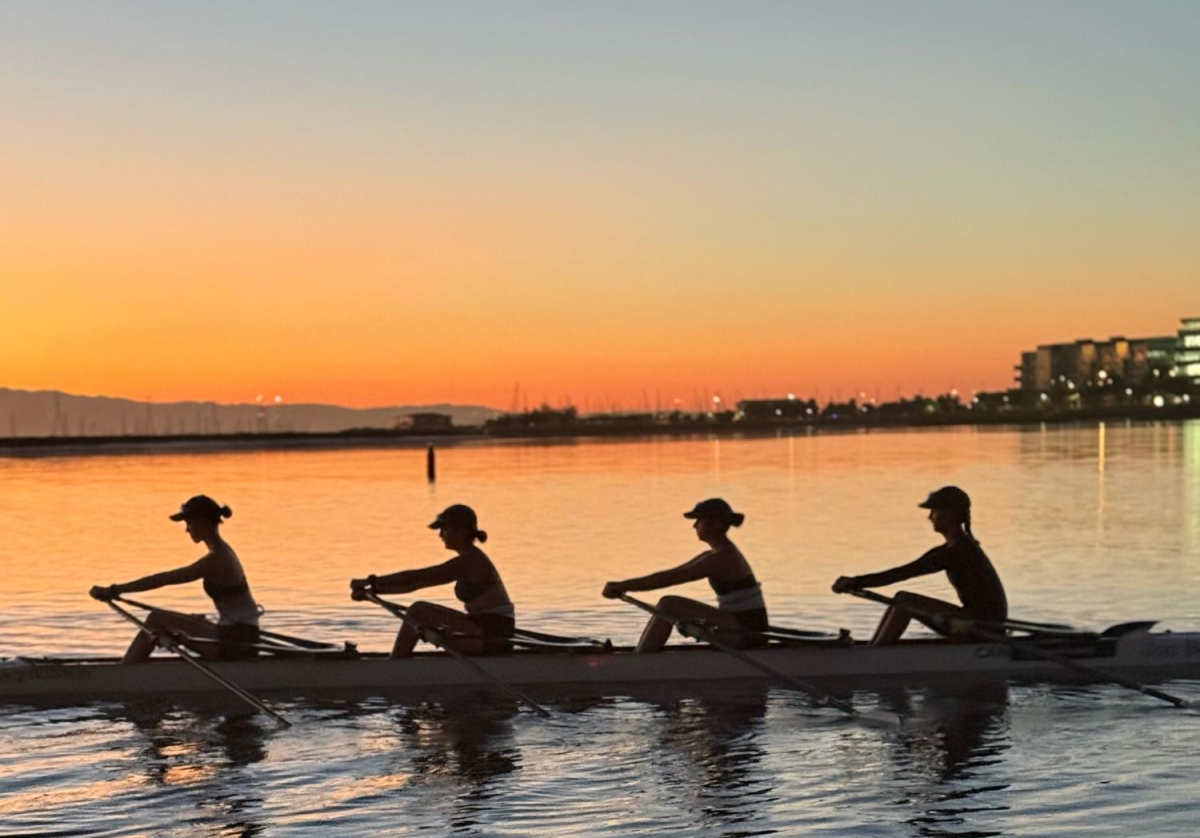 SUNRISE PRACTICE — Flynn rows through the sunrise with three Redwood Scullers teammates. “If I have a really good practice, I’ll come off the water and I just want to talk about it with everyone because I’m so happy about how it was,” Flynn said. “It makes me happy to be with my friends, doing something that’s hard, but it’s so much fun.”