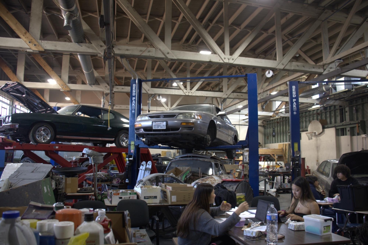 FUELING UP — Students eat lunch in the Automotive Technology classroom, surrounded by cars. Automotive teacher Doyle Knight used a Viking grant to help him pay for parts for an electric vehicle. “Yeah, that [the grant] was very beneficial,” Knight said. 